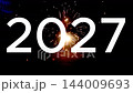 2027 new year white number over ground firework fountain spraying orange sparks on dark night 144009693