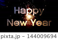 Happy new year text with ground firework fountain spraying orange sparks on dark night background 144009694