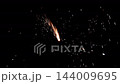 New year firework shooting golden sparks in dark night, glowing streaks and flying embers 144009695
