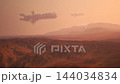 Science fiction spacecraft fleet flying over orange alien desert 144034834